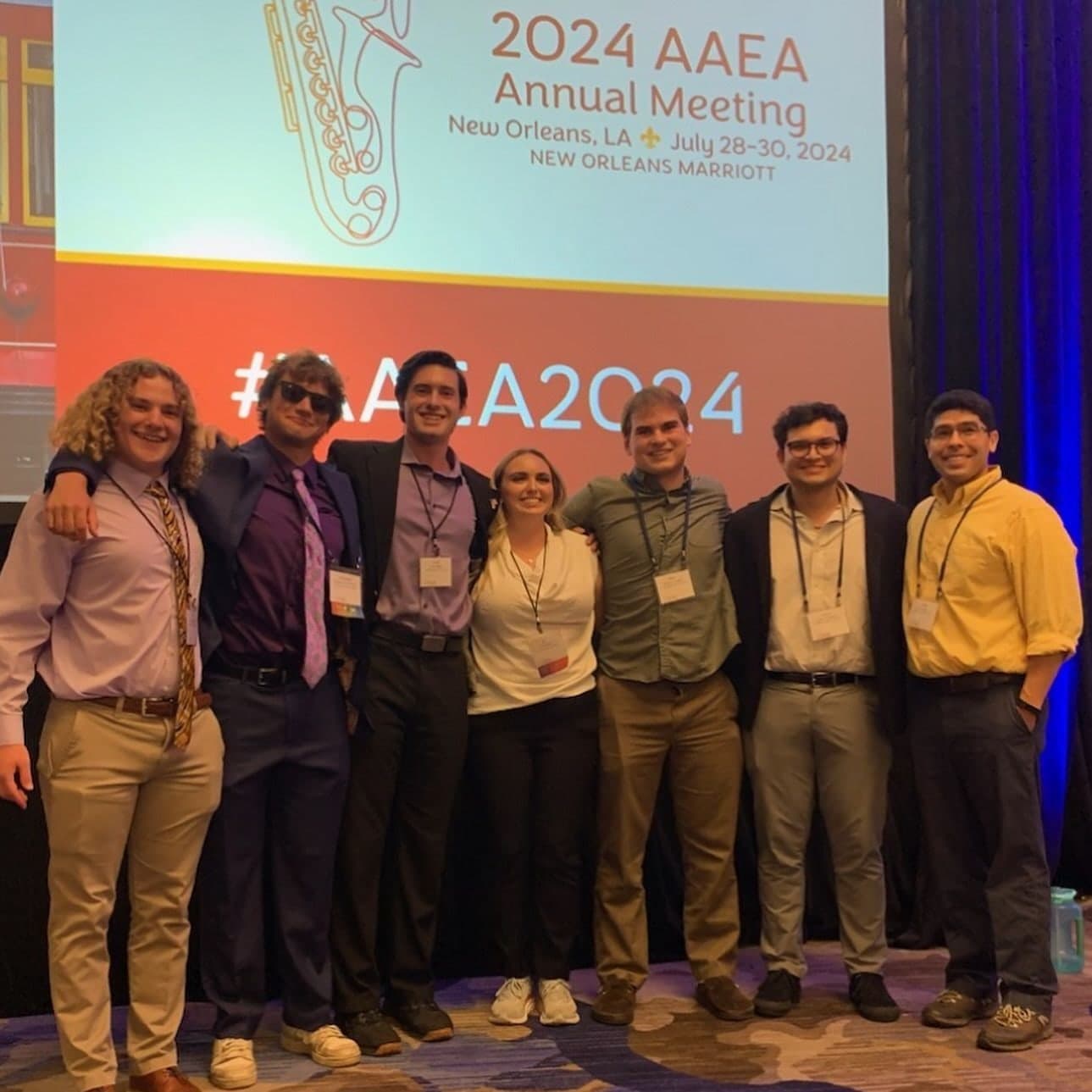 The LSU Academic Bowl teams in front of the 2024 AAEA Annual Meeting sign in New Orleans