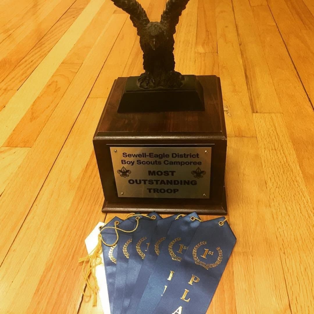 The Sewell-Eagle District Boy Scouts Camporee Most Outstanding Troop trophy, a bronze eagle on a wooden base, with a row of first-place ribbons