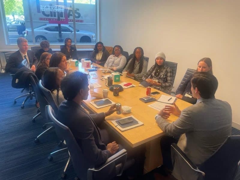 FIU scholars around a conference table during the discussion, Colin Raby among them