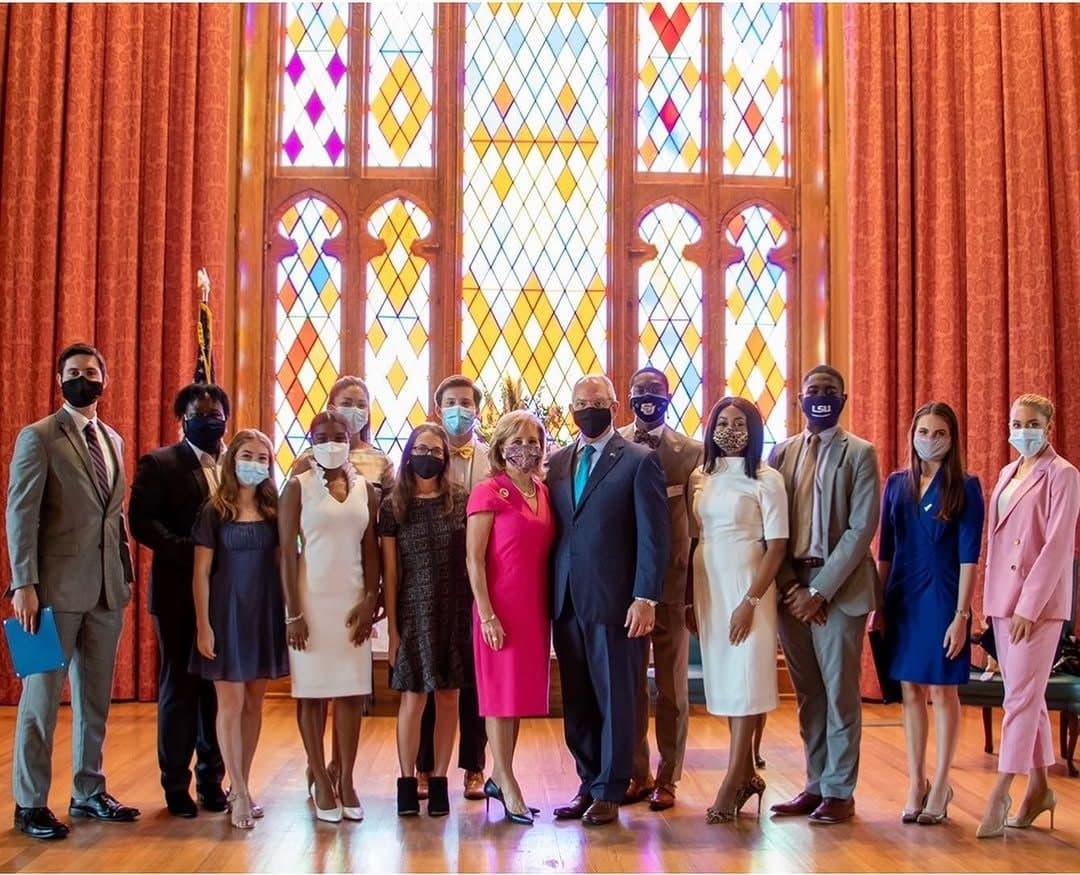 The 2021 Lamar Governor's Fellows with Gov. John Bel Edwards and First Lady Donna Edwards in front of stained-glass windows