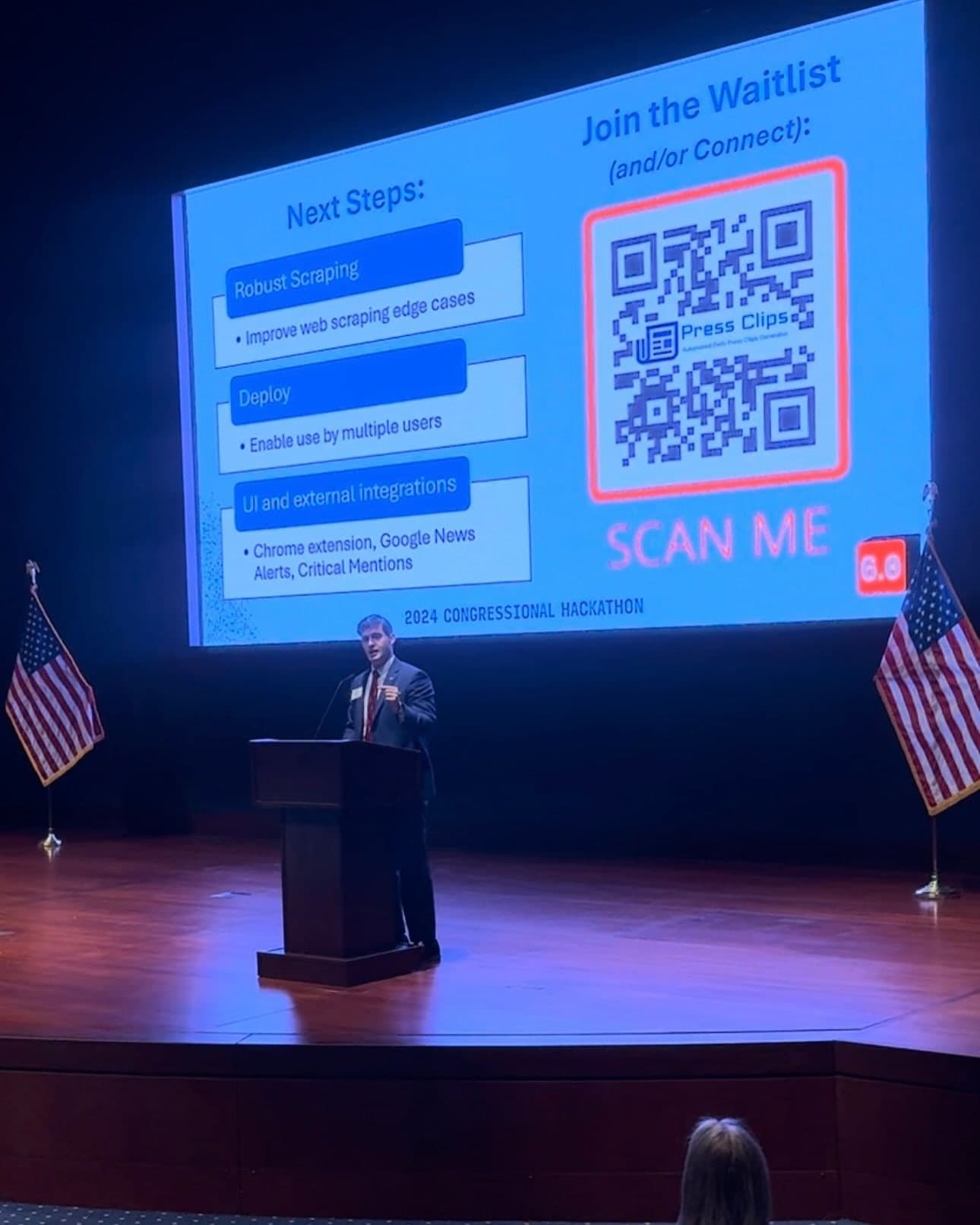Colin Raby presenting beneath a “Next Steps” slide with a QR code to join the tool's waitlist