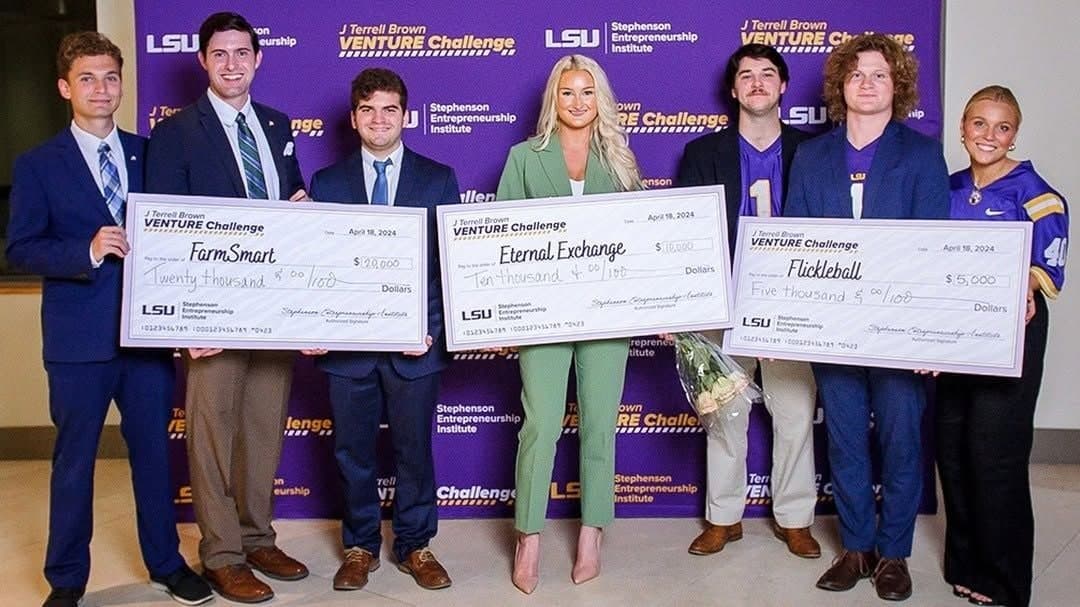 The 2024 J Terrell Brown Venture Challenge winners holding oversized checks; FarmSmart's Julius Pallotta, Colin Raby and Grant Muslow at left with the $20,000 check