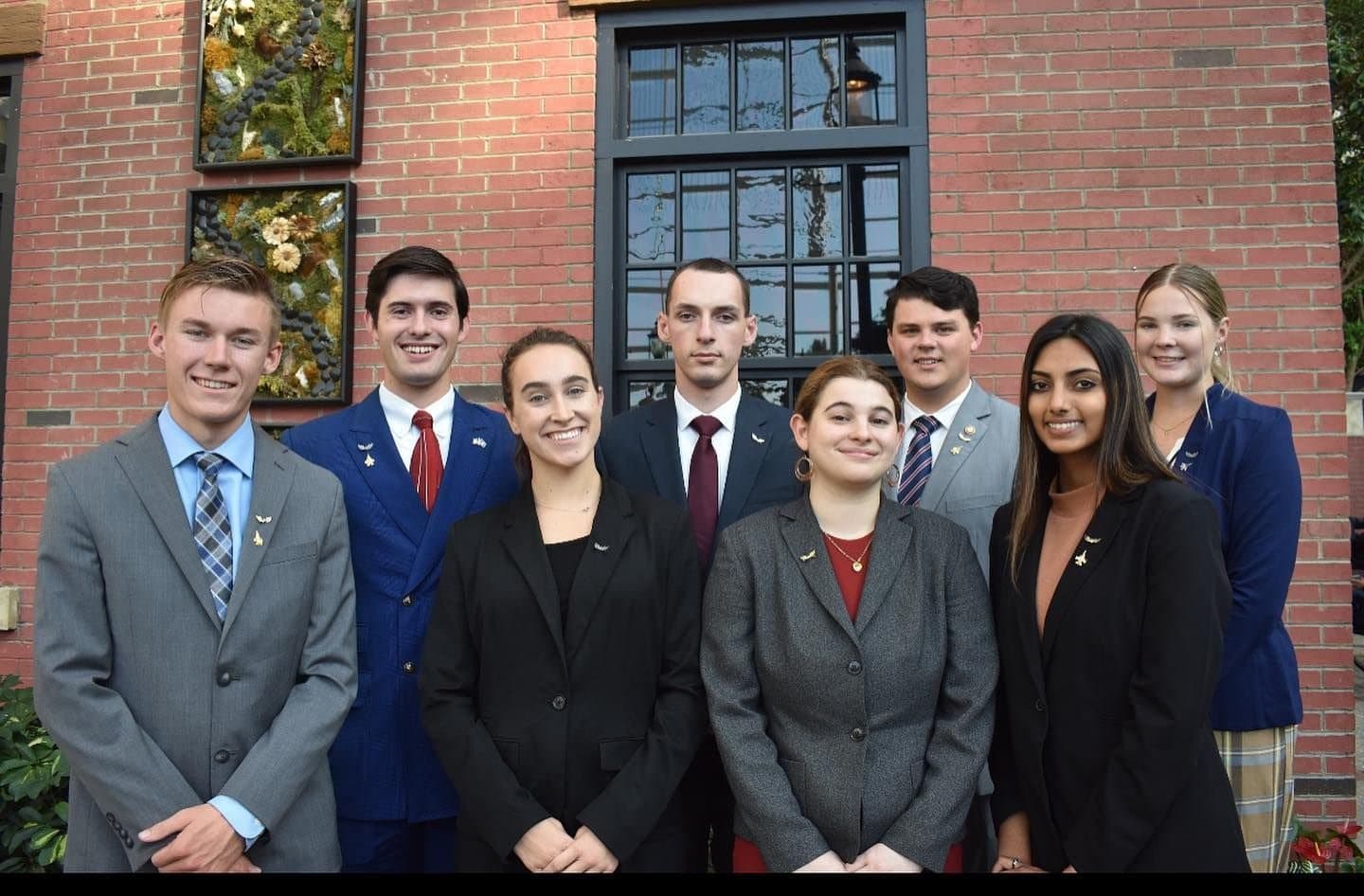 Colin Raby with fellow Silver Wings leaders outside a brick building